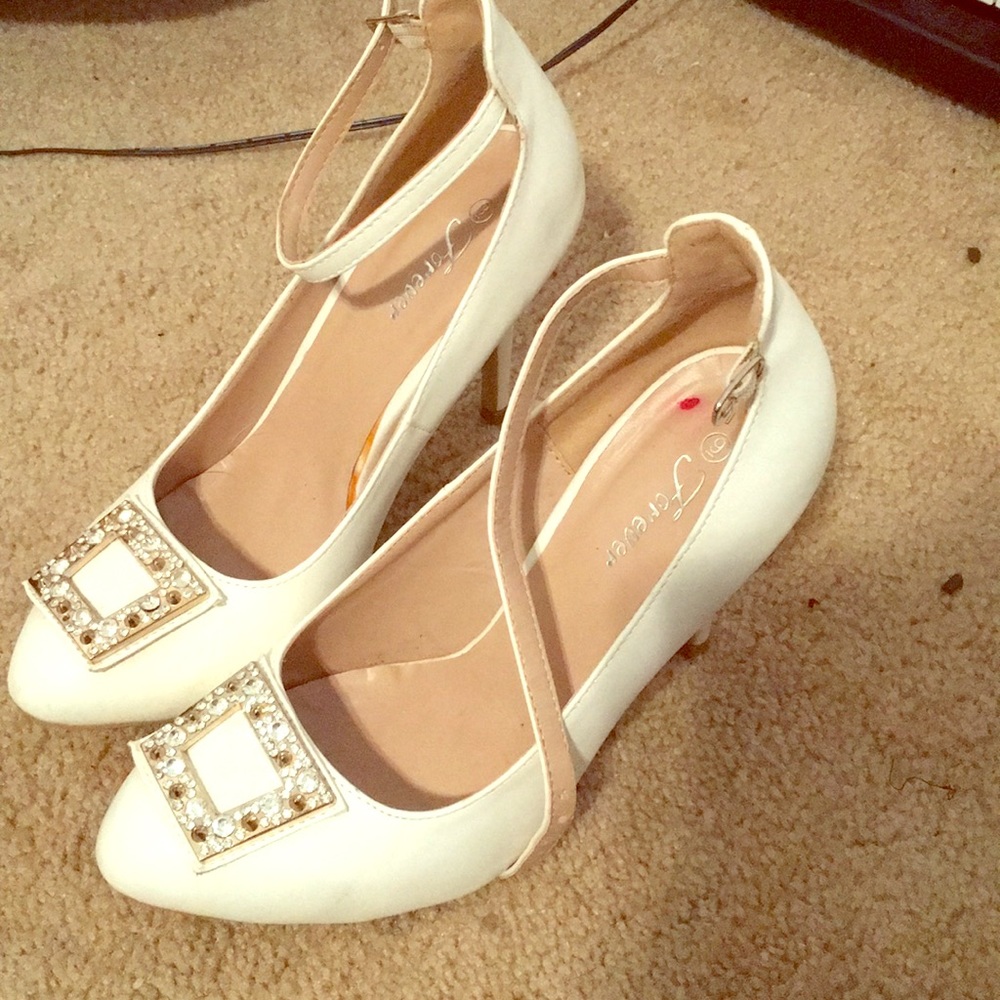 White heels with a jewel covered square on toes
